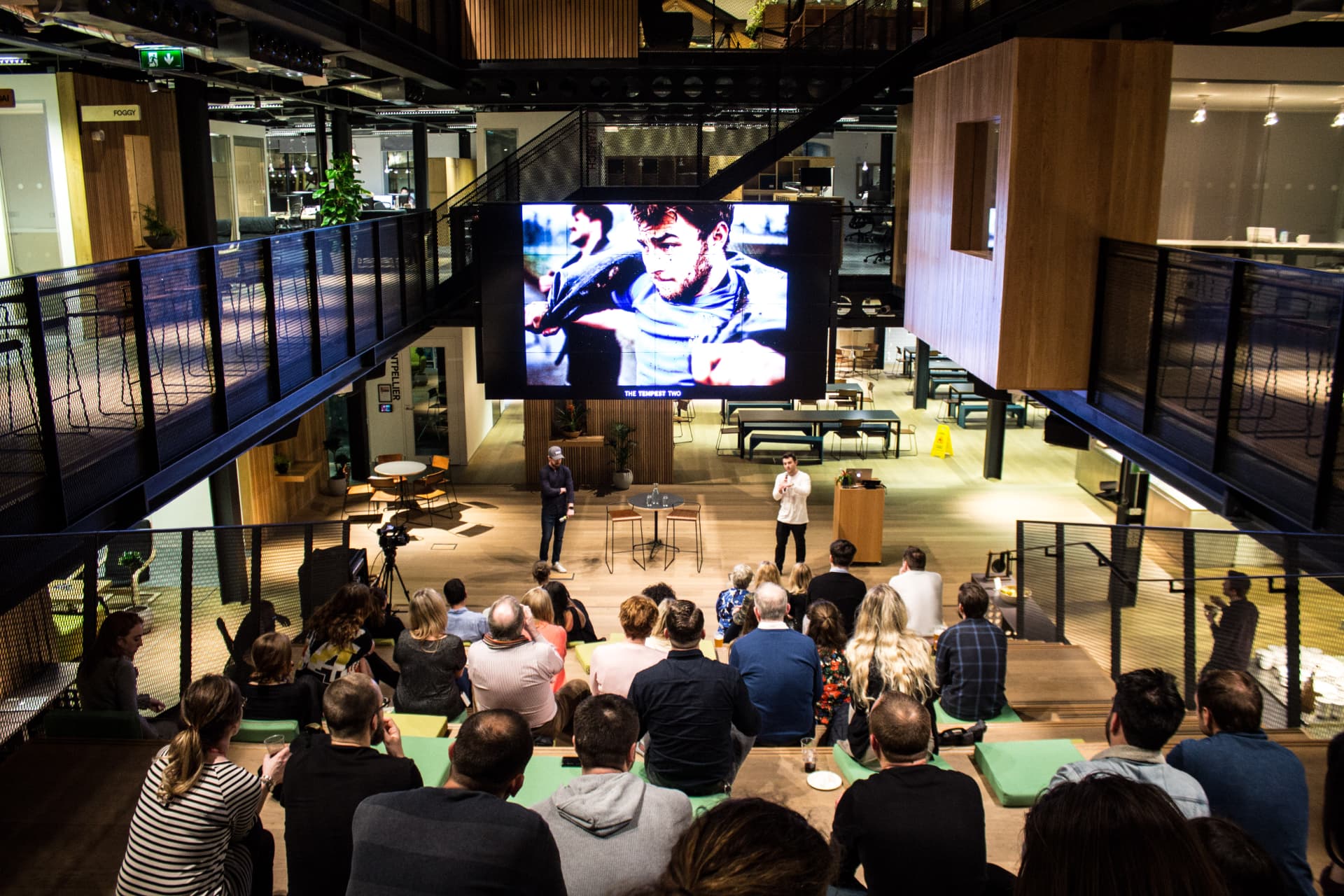 Airbnb team attending a Tempest Two presentation in a modern office auditorium